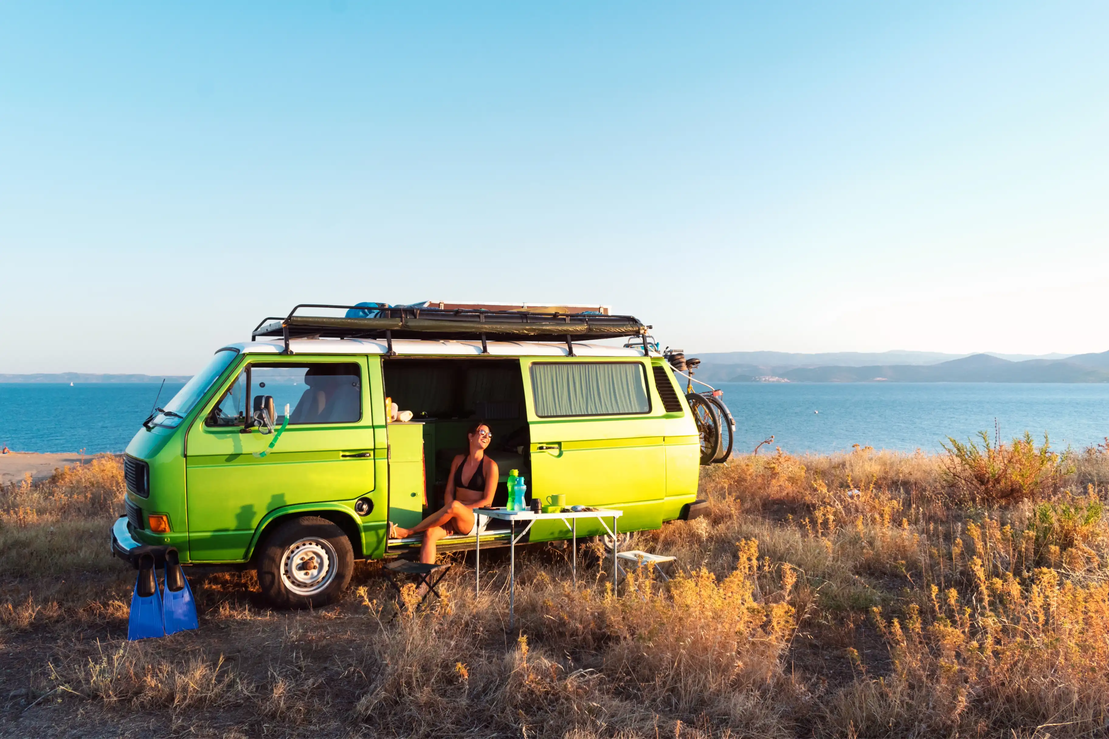 Person and campervan in the beach
